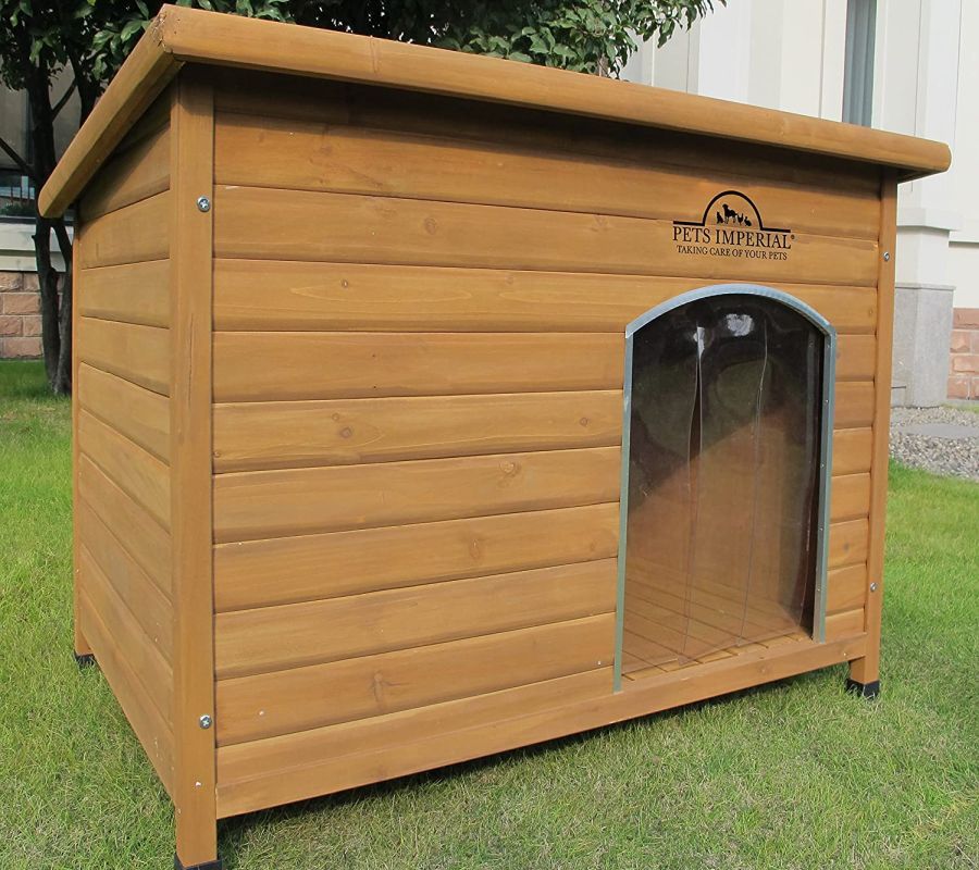 Pets Imperial Extra Large Insulated Wooden Dog Kennel standing on a lawn.
