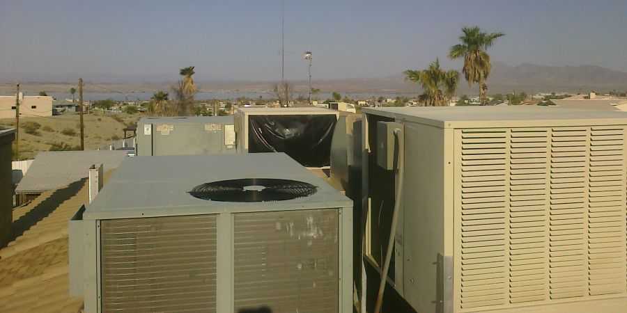 Evaporative swamp coolers sitting on top of a house in Florida.