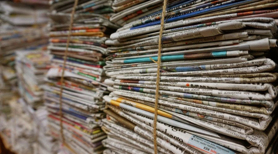 stacked and bundled newspapers