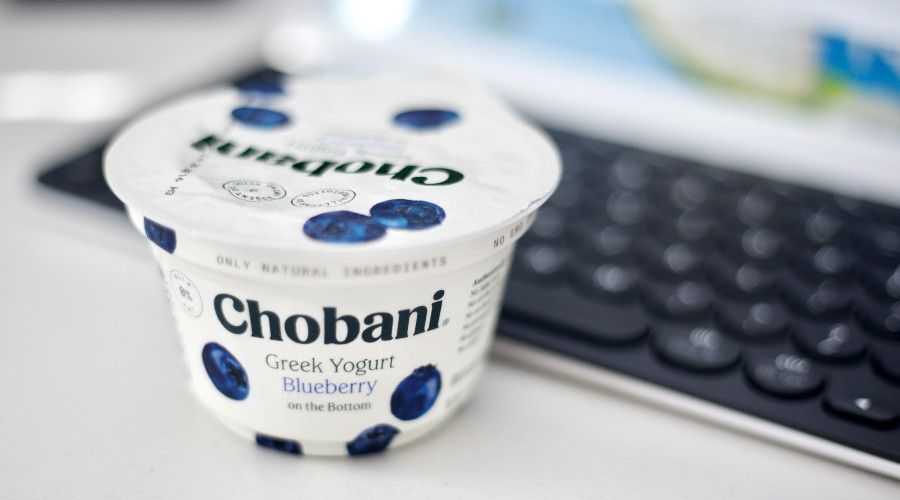 yogurt container &quot;Chobani&quot; blueberry flavor in front of keyboard