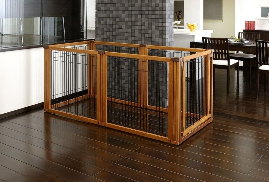 A freestanding, extra-wide, convertible dog gate of wood and wire.