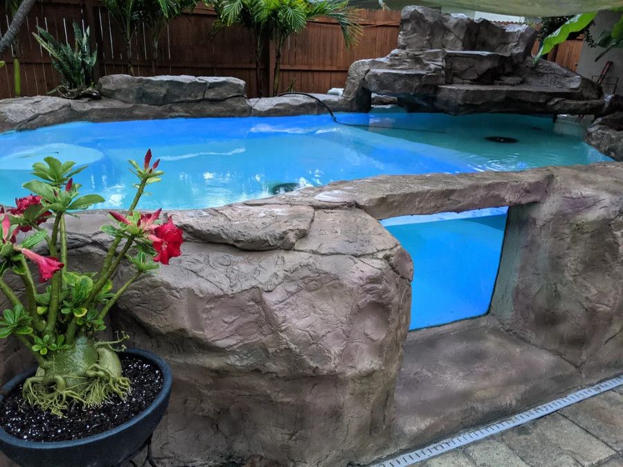 Glass and concrete koi pond with window