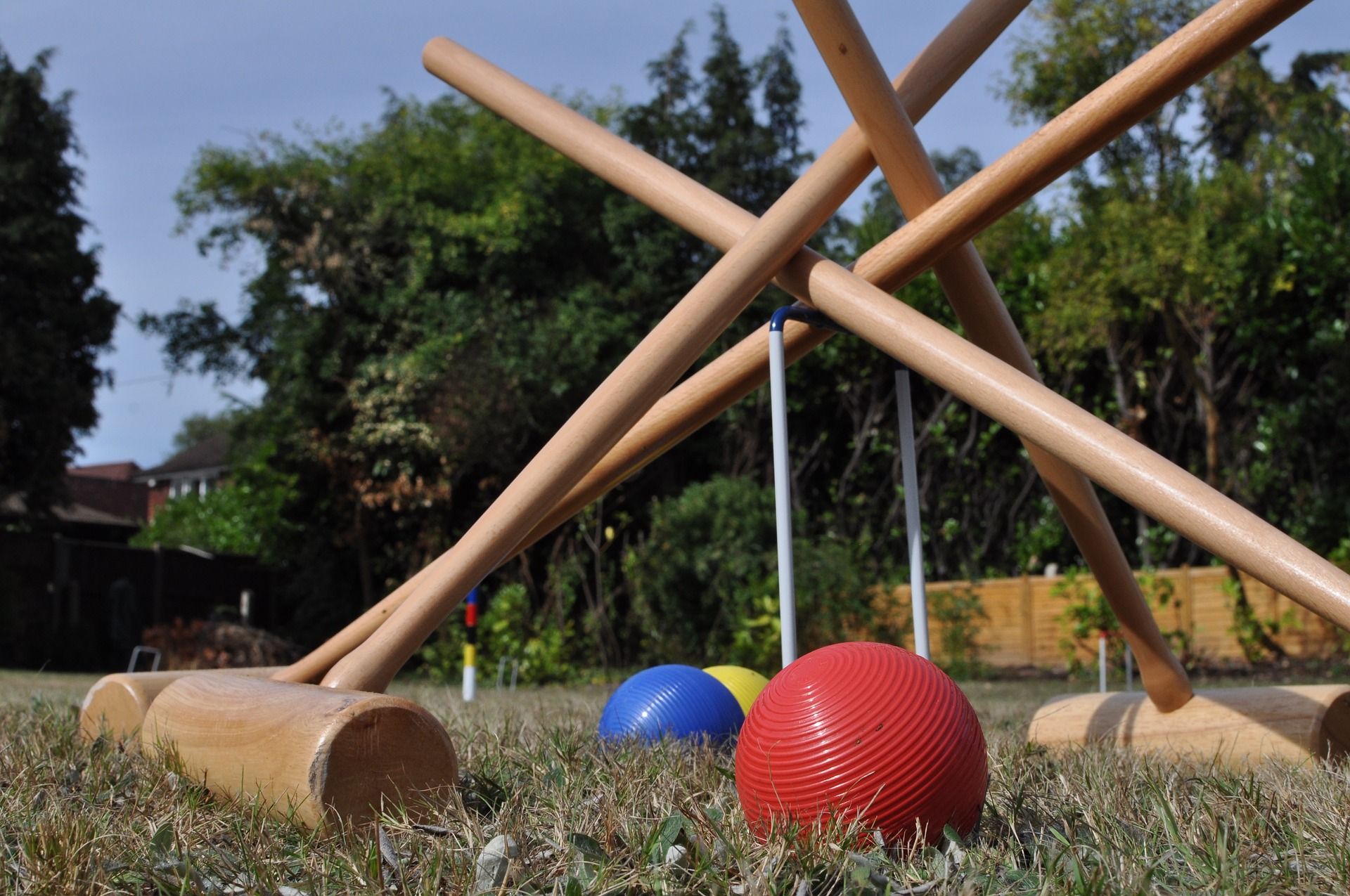 Croquet mallets standing above the balls