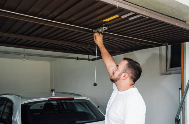 man opens garage door made of sheet metal