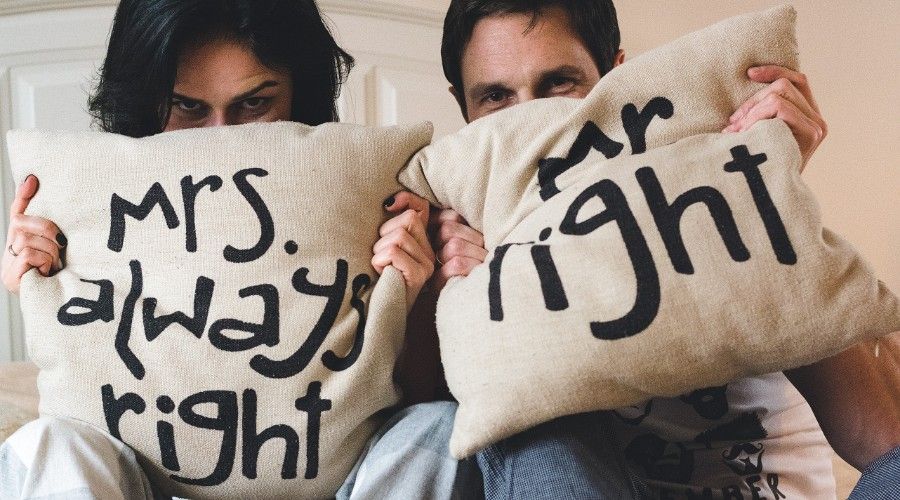 a man and a woman holding pillows that state Mrs Always Right and Mr Right