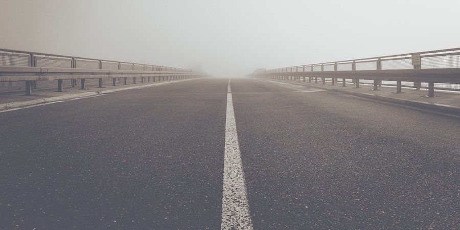 Asphalt road in fog 