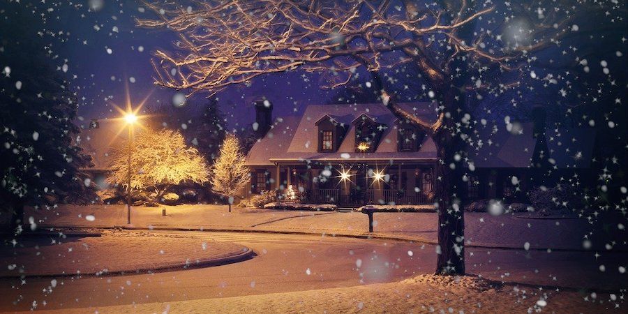 House at night in snowy neighbourhod