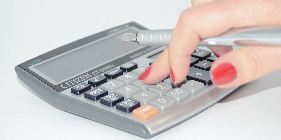 Hand using a calculator 