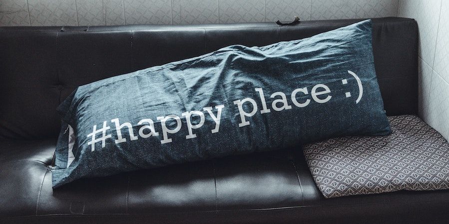 Black couch with #happyplace pillow