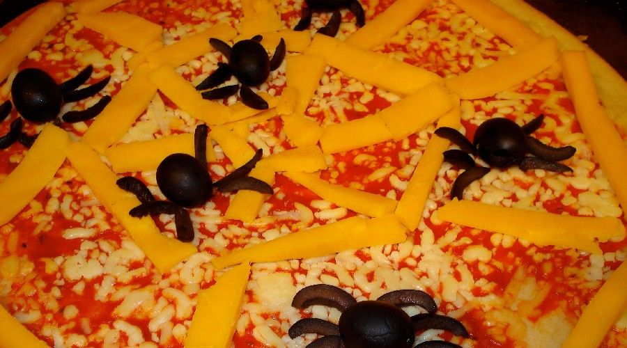 olive spiders on a pizza