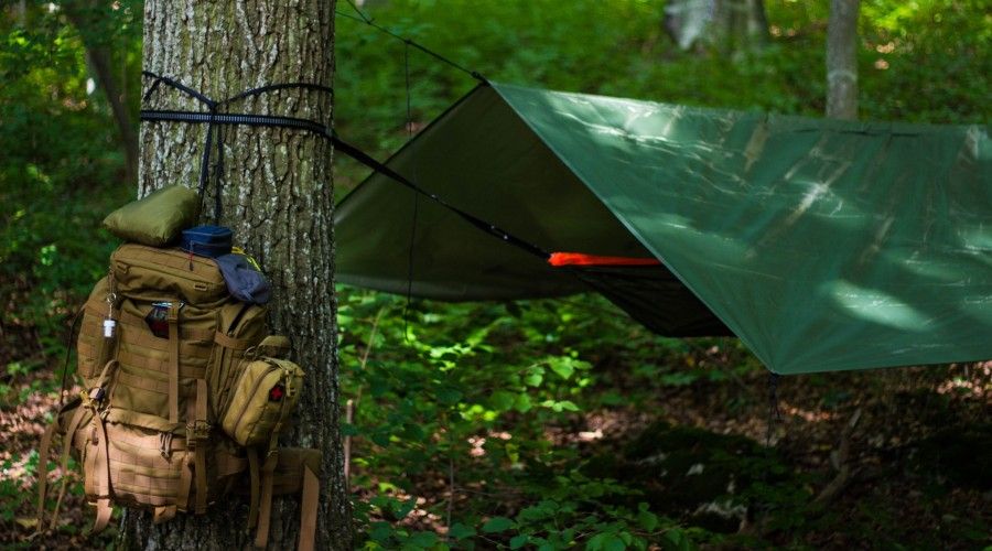 tarp strung up over a hammock to use as a tent