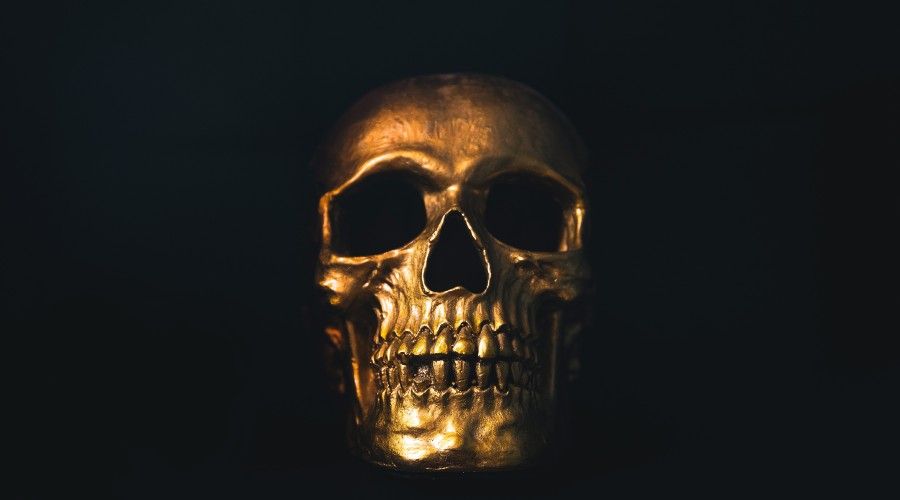 Golden skull on black background