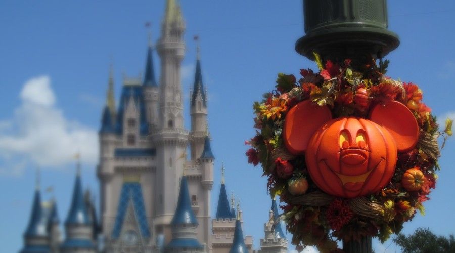 Pumpkin carved like Mickey Mouse in a wreath on a post at Disneyland