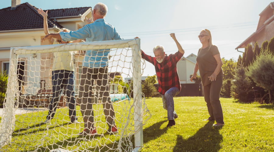 Family playing backyard soccer