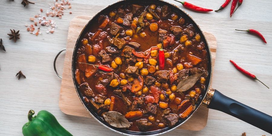 Beef stew in a pan on a cutting board 