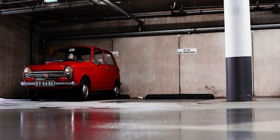 Small red car in a parking garage 