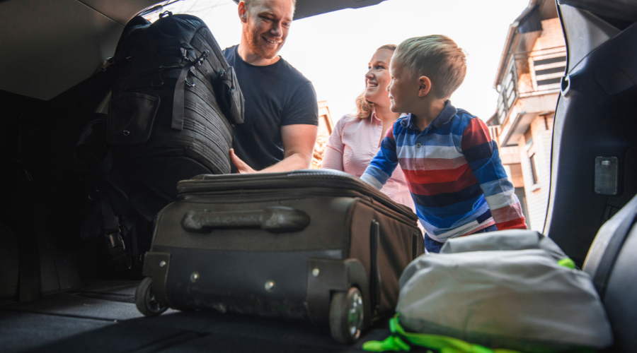 Family packing car with suitcases