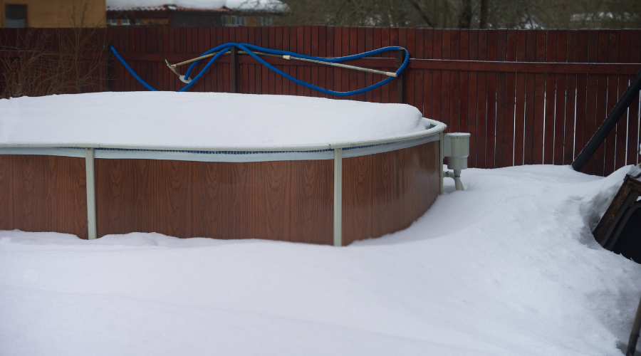 Above-ground pool covered with snow