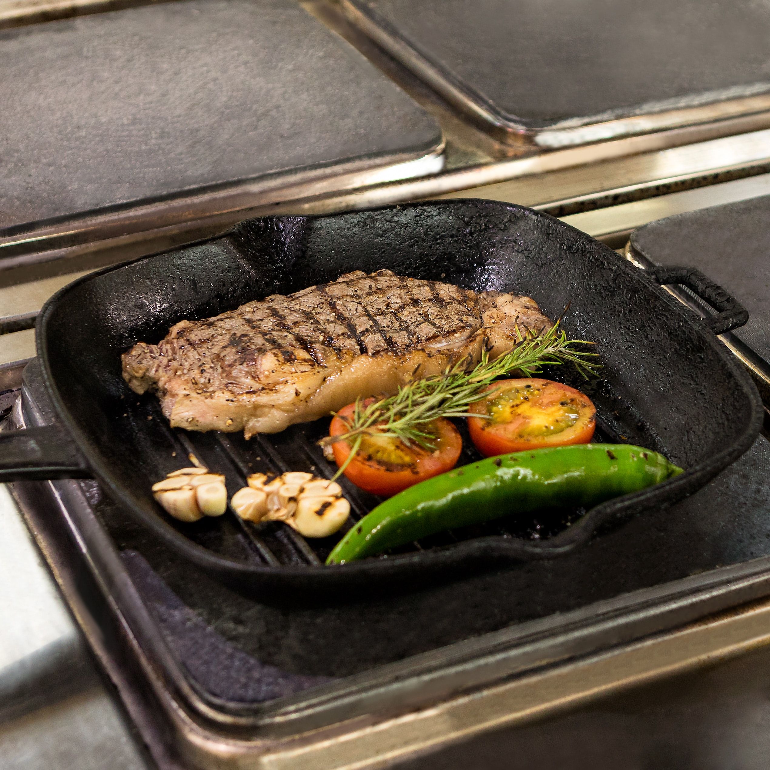 Grilling pan with meat and veggies on it