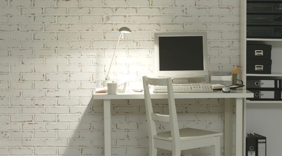 home office in front of a white brick wall