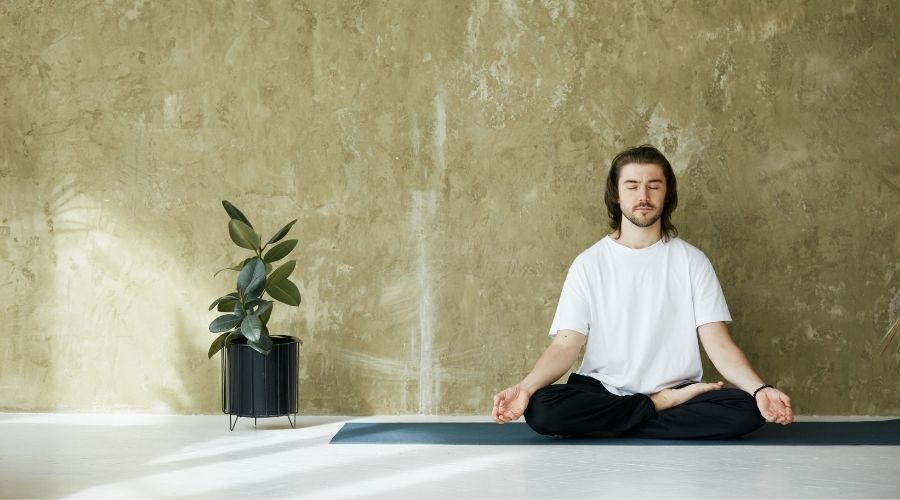 man meditating on yoga mat