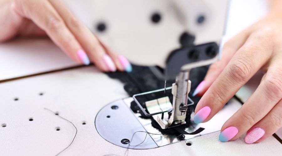 close view of a person using a sewing machine