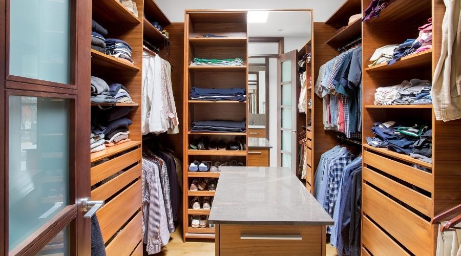 walk-in closet with wooden shelving