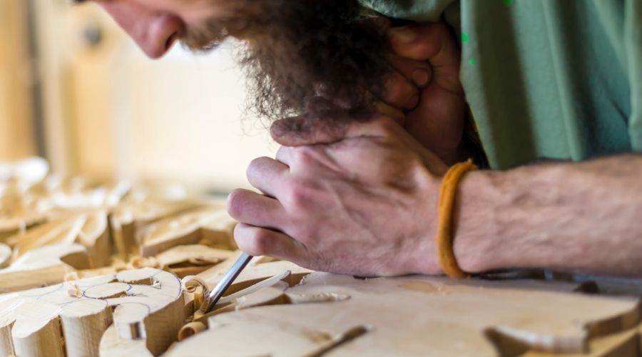 man doing wood carving