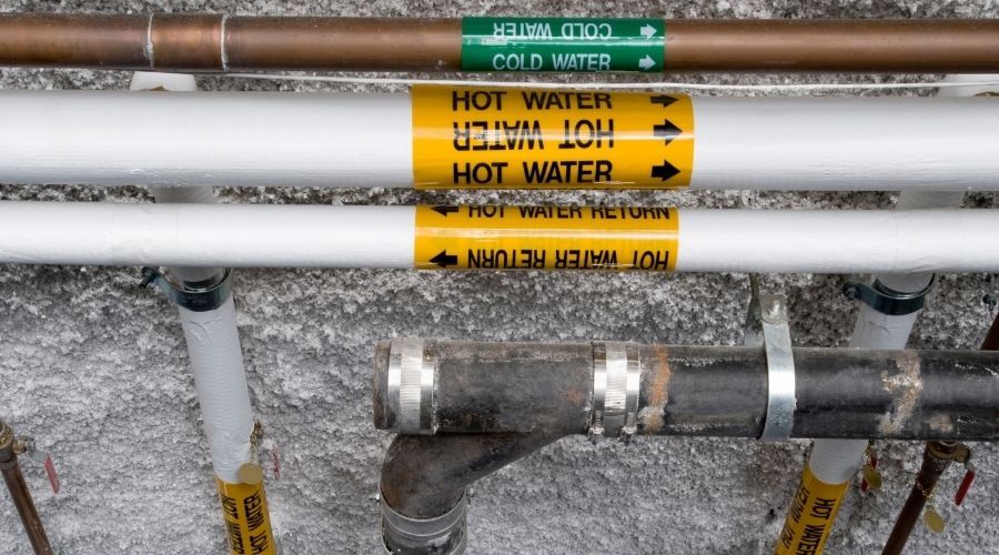 plumbing pipes labelled hot and cold water