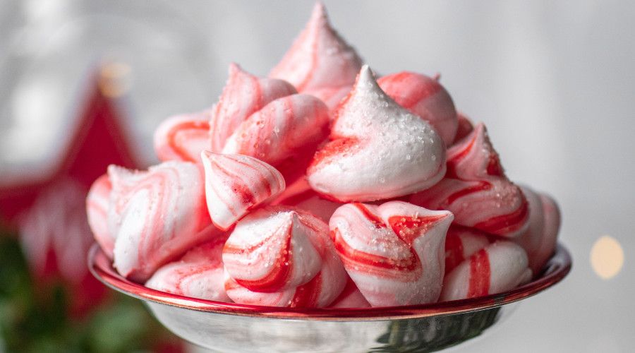 Peppermint striped meringues in a silver dish