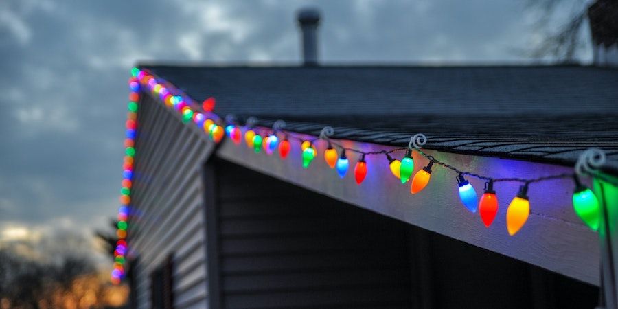Colorful lights along the eaves of a roof 