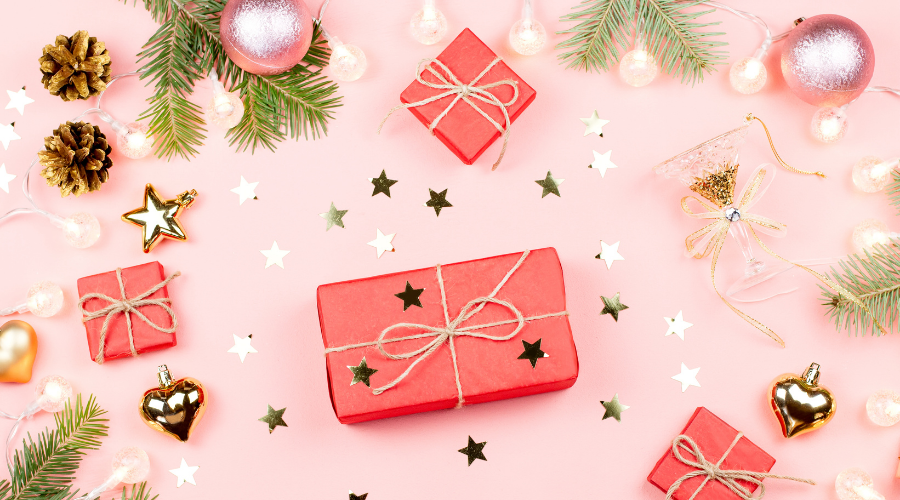 Gifts and Christmas Decor on Pink Background