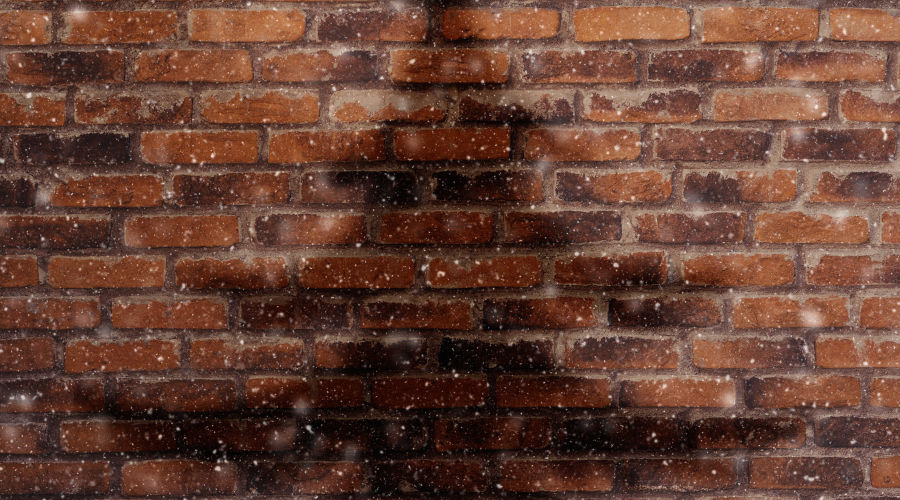 Shadow Of Christmas tree on brick background with snow