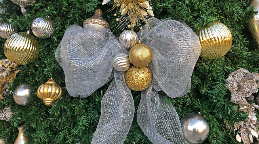 Ribbon and Gold and Silver Christmas Ornaments on Tree