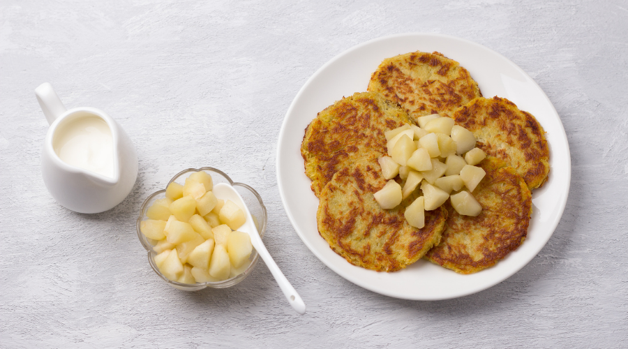 Traditional latkes fritters with sour cream and apple sauce