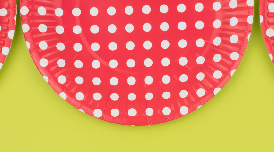 Colored paper plates on a bright green background.