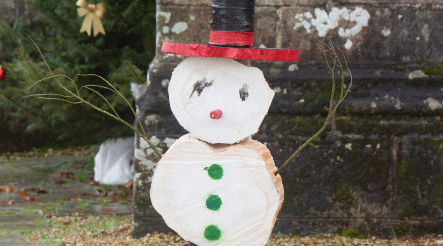 Snowman made in wood logs