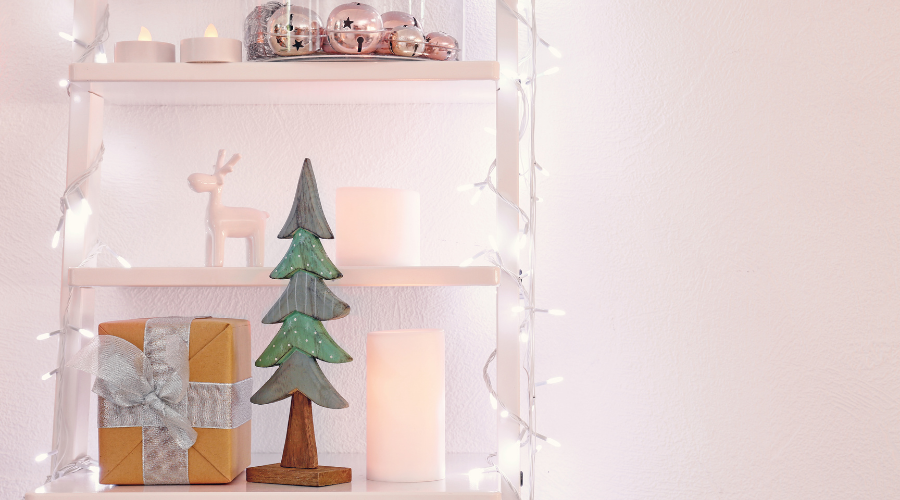 Shelves with Decorations and Christmas Lights near White Wall