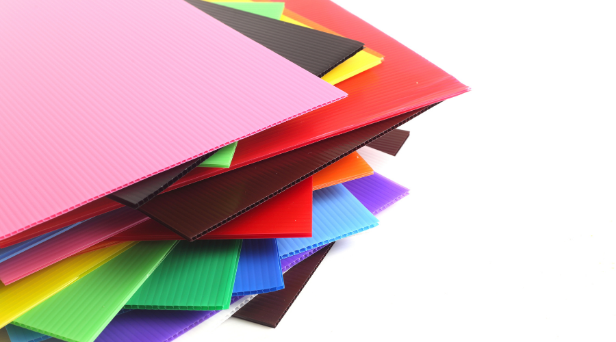 Group of colorful corrugated plastic sheets on white