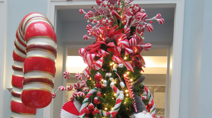 Christmas tree beside giant candy cane