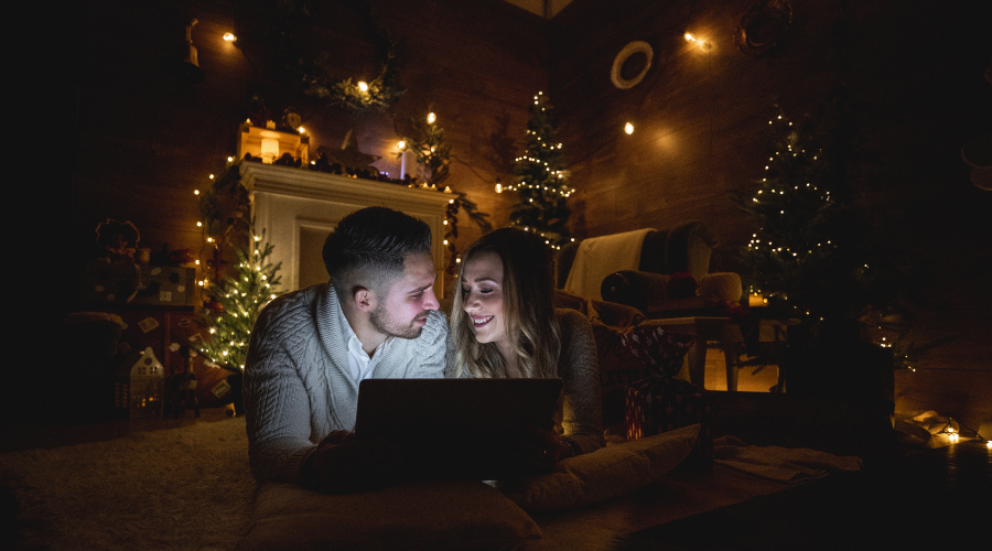 Young couple watching movies on christmas eve