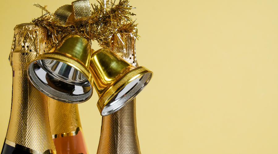 Bottles of different champagne and golden Christmas bells