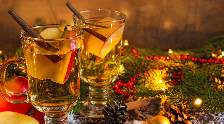 hot mulled apple cider with spices and christmas lights