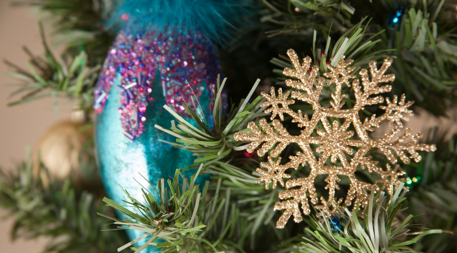 Teal blue, purple Christmas ornament, decorations on tree.