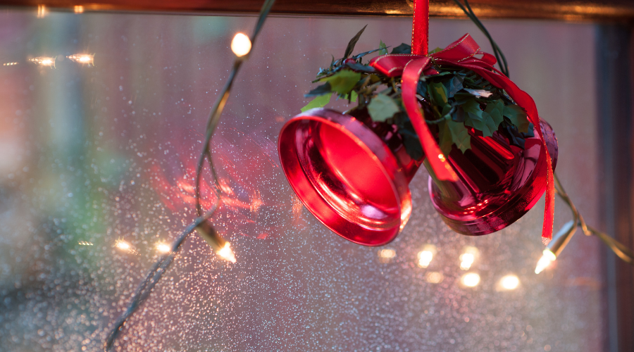 christmas bells and light decorations on window background