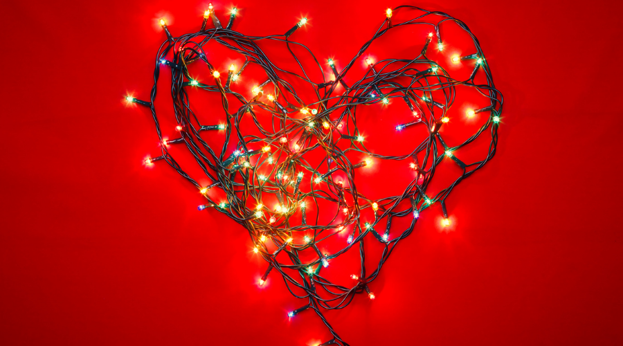 Heart-Shaped Christmas Lights on Red Background