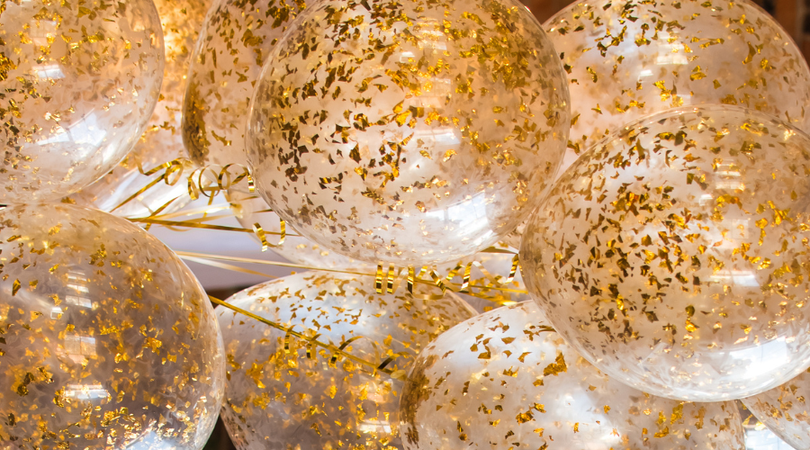Christmas tree near the window, inflatable gold balls. new year 2019