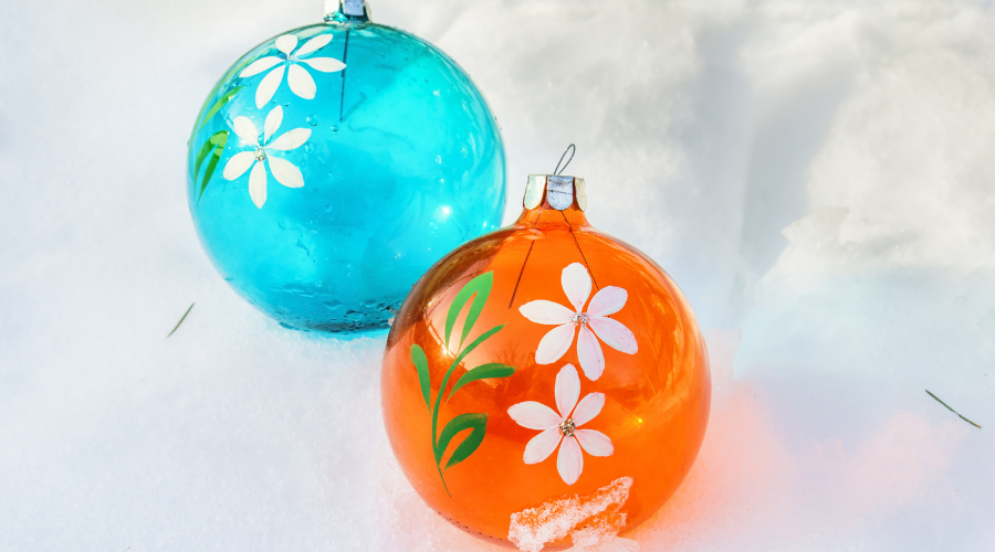 Orange and blue Christmas balls on snow