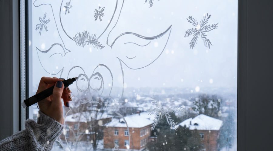 Female Hand Painting Christmas Deer Painted on Window Glass