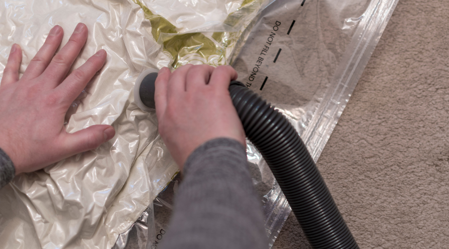 Using a vacuum storage bag to remove air from duvet